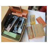 assorted vintage staplers and staples