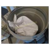 trash bin w full bag grass seed,