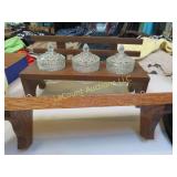 3 glass covered containers in wood holder shelf
