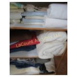 linens bottom cabinet towels blankets rug