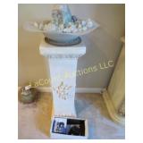 water fountain w stones on pedestal lighted