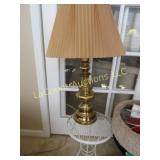 brass lamp w shade on small patio side table