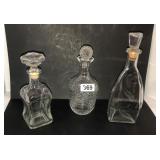 3 heavy glass decanters with stoppers