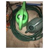 2 plastic watering cans and hose