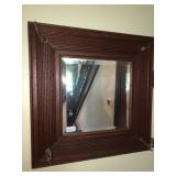 Beveled wall mirror in frame with hooks