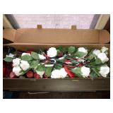 Silk roses and votive candles and glasses