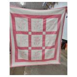 Hand-Stitched Pink and White Quilt with Floral Des