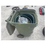 Garbage can full of trash pump hoses