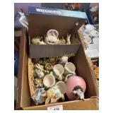 Box of Easter, decorations, and coffee mugs