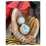 vintage baseball gloves and two baseball