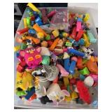 tote full of Pez dispensers and Furbies