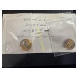 Two gold and platinum dollar coins   TC