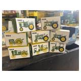Eight John Deere tractor collectibles
