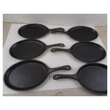 Six Oval Cast Iron Skillets