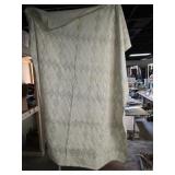 Vintage hand sewn diamond-pattern quilt. Some