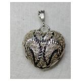 Silver heart-shaped pendant marked 925. Silver heart-shaped pendant marked 925.