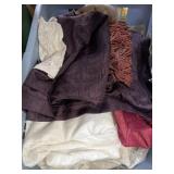 Mix of drapery, curtains in laundry basket Mix of drapery, curtains in laundry basket
