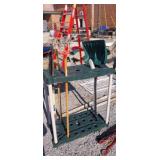 Garden tool rack with assorted garden tools