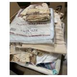 Clean twin bedding in lined basket