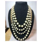 White and gold beaded necklace marked Carolee LUX