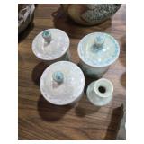3 covered jars and a bud vase
