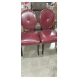 Matching pair of red leather armless chairs