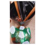 Metal bucket of tools with vintage spark plug