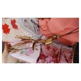 Box of table cloths, afghan & brass wall hanging