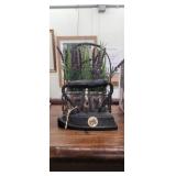 Cast iron iron and wire basket with fuax flowers