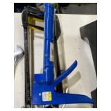 Two metal hacksaws and caulk gun