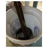 5 gallon bucket with two horseshoes and stakes