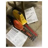 Two cordless handheld hedge trimmers