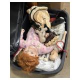 Tote of porcelain dolls, clothing, parts