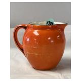 Vintage orange creamer "Celebrate Pottery"