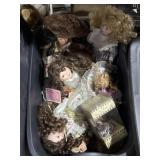 Tote of porcelain dolls, clothing, parts