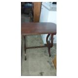 Ornate wooden side table. Has some damage