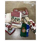 Box of Christmas towels, pot holders, and place