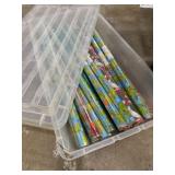17 rolls of wrapping paper in storable tote