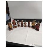 Group of carved folk art figurines, including