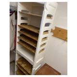 This is a white plastic storage shelf with wooden