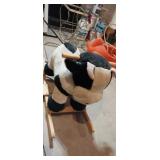 Plush cow rocking toy has damage