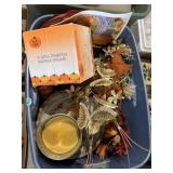 Tote of fall-themed home decor items, candles,