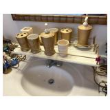 Over the sink stands with bathroom decor contents