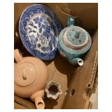 Variety of tea, pots, decorative plate, and