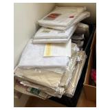 Crate full of new linens, curtains etc.