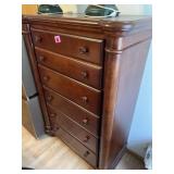 Five-drawer wood dresser in a cherry finish 54"