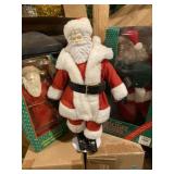Three Santa figurines, one 12 inches tall two are
