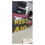 Futon chairs and rest ahead wooden sign