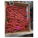 Box of red pegboard hangers