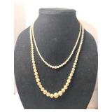 Two strands of pearls (one coming apart)